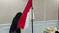 Siska Nur Azizah mencium bendera merah putih usai mengucapkan ikrar setia pada NKRI. Foto: Febri/berandaperistiwa
